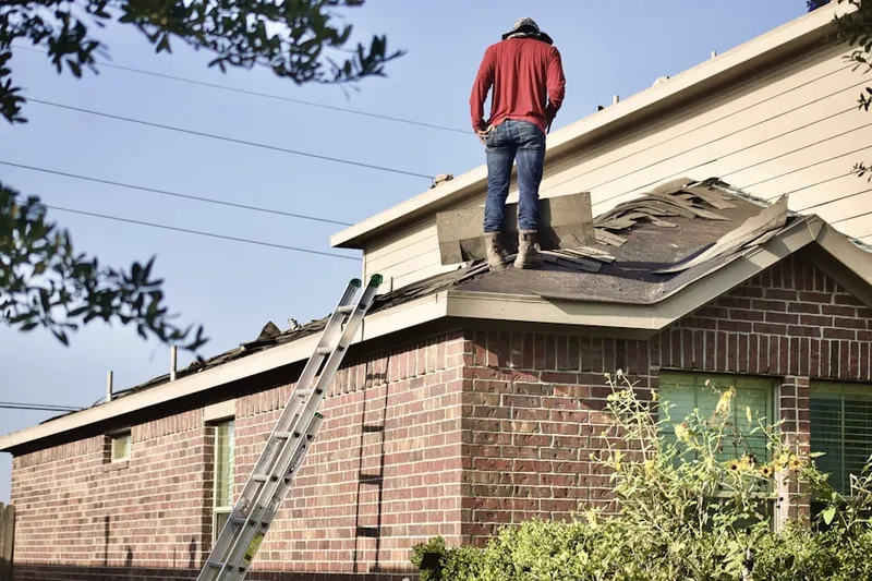 Professional roofer working on a residential roof in Weslaco